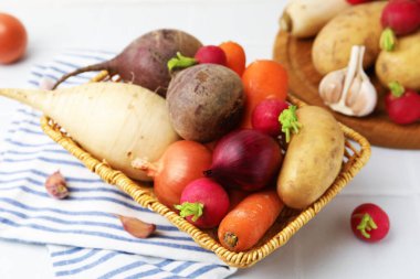 Beyaz masada farklı çiğ sebzeler, yakın plan.
