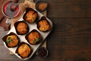 Kuru üzümlü lezzetli kekler, nane şekeri ve ahşap masa üzerinde çay, üst manzara. Metin için boşluk