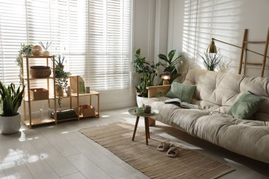 Kanepesi ve çiçekleri olan şık bir oturma odası. İç tasarım