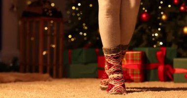 Evdeki Noel ağacına karşı rahat çoraplı kadın, yakın plan.