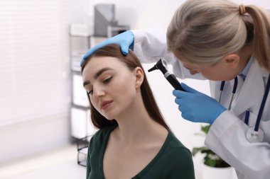 Duyma testi. Klinikte hastanın kulağını yıldız falıyla muayene eden doktor.