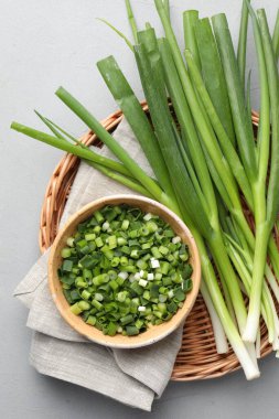 Gri masada taze taze soğan var, üst tarafta.