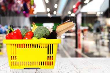 Süpermarketteki ürünlerle dolu bir alışveriş sepeti. Metin için boşluk