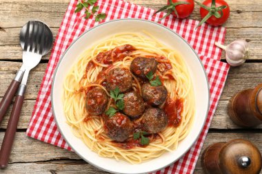 Köfteli lezzetli makarna ahşap masada servis edilir.