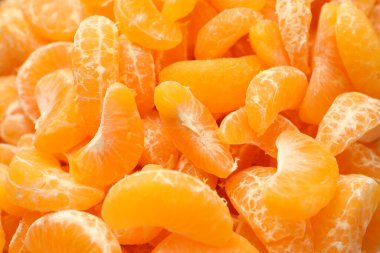 Arka plan olarak birçok olgun soyulmuş mandalina, üst görünüm