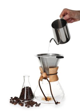 Beyaz arka planda cam kimya kahve makinesine sıcak su döken kadın, yakın plan.