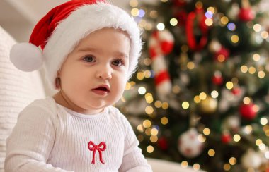 Evde Noel Baba şapkalı şirin bir bebek, mesaj için yer var. Bebeğin ilk Noel 'i