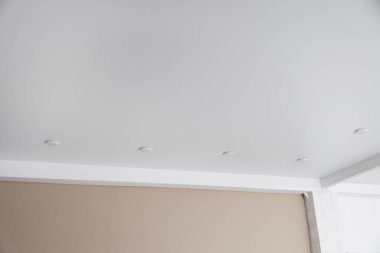 Kapalı mekanda benekli beyaz tavan, yakın çekim.