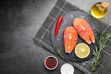Baharatlı, limonlu ve yağlı somon filetosu, gri desenli masa, düz. Metin için boşluk