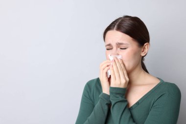 Hafif arka planda burnu akan bir kadın, mesaj için yer var. Soğuk Semptom