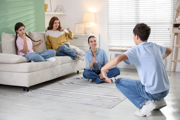 Evde sessiz sinema oynayan bir grup genç.