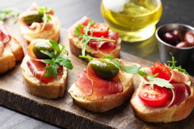 Krem peynirli, jambonlu, yeşil zeytinli, domatesli ve roka soslu nefis bruschetalar.