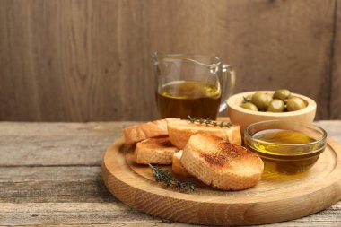 Ekmek dilimleri, yağ, zeytin ve kekik, ahşap masada, yakın plan. Metin için boşluk