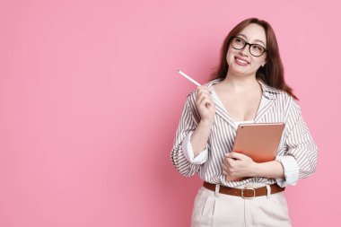 Pembe arkaplanda tableti olan tasarımcı, metin için boşluk