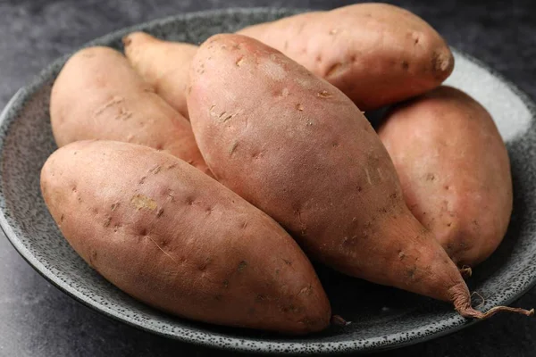 Siyah masada çiğ patates, yakın plan.