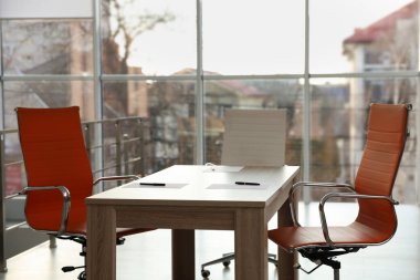 Ofisteki ahşap masada kağıt ve kalemler, yakın plan.