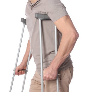 Beyaz arka planda koltuk değnekli adam, yakın plan