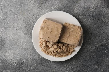 Compressed yeast on grey table, top view