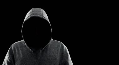 Anonymous man in hood on black background, banner design. Criminal concept