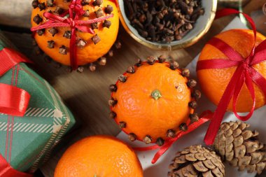 Olgun mandalinalar, kurdeleler, baharatlar, hediye ve koniler ahşap masa, düz yatıyordu.