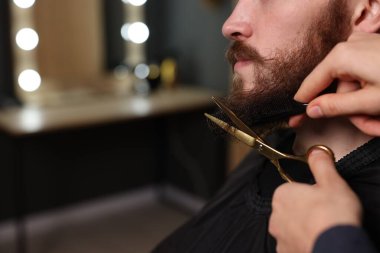 Berber dükkanında adamın sakalını buduyor, yakın plan. Metin için boşluk