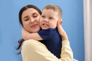 Mutlu anne evde oğluna sarılıyor.