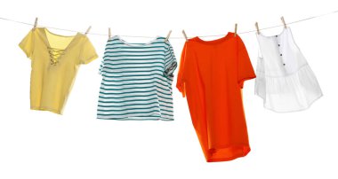 Çamaşır ipini beyaz arka planda tutarken farklı giysiler kuruyor