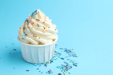 Açık mavi arka planda serpiştirilmiş lezzetli kek, yakın plan. Metin için boşluk