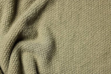 Arka plan olarak zeytin örülmüş kumaş dokusu, üst görünüm