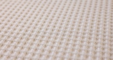 Arkaplan olarak bej waffle kumaş dokusu, yakın plan