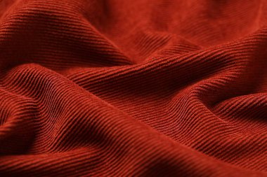 Arka plan olarak kırmızı-kahverengi kumaşın dokusu, yakın plan