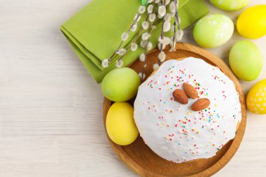 Lezzetli Paskalya pastası, boyanmış yumurtalar ve söğüt dalları beyaz ahşap masa, düz yatak. Metin için boşluk