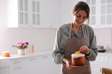 Mutfakta geleneksel paskalya pastası olan genç bir kadın, mesaj için yer var.