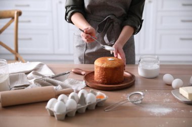 Geleneksel Paskalya pastasını mutfakta jöleli dekore eden genç bir kadın.