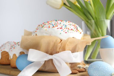 Lezzetli Paskalya pastaları, boyanmış yumurta ve laleler, yakın plan.