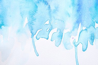 Abstract blue watercolor painting on white paper, top view