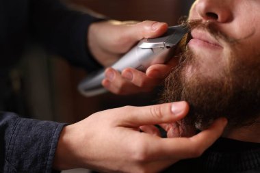 Berber dükkanında adamın bıyığını buduyor, yakın plan