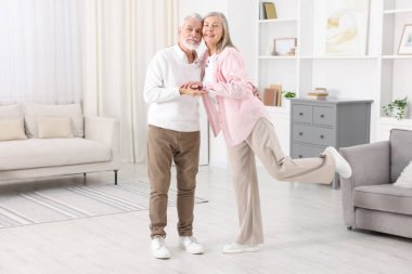 Güzel yaşlı çift evde dans ediyor.