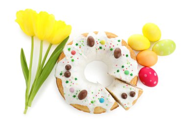 Lezzetli Paskalya pastası, boyanmış yumurtalar ve beyaz laleler, üst manzara.