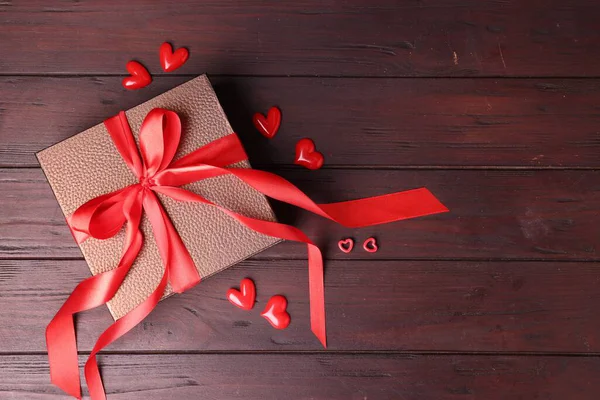 Sevgililer Günü. Hediye kutusu ve dekoratif kalpler tahta masada, düz yatıyordu. Metin için boşluk