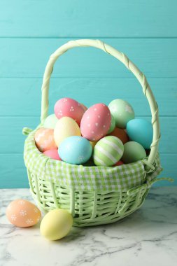 Beyaz mermer masanın üzerinde mavi ahşap arka planda güzel Paskalya yumurtaları.