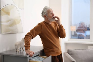 Hafıza kaybı. Kıdemli adam evde bir şeyler hatırlamaya çalışıyor.