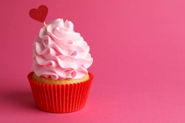 Sevgililer Günün kutlu olsun. Pembe arka planda kırmızı kalp kaplamalı lezzetli kek, yakın plan. Metin için boşluk