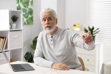 Hafıza kaybı. Bilgisayarlı son sınıf öğrencisi beyaz masada bir şeyler hatırlamaya çalışıyor.