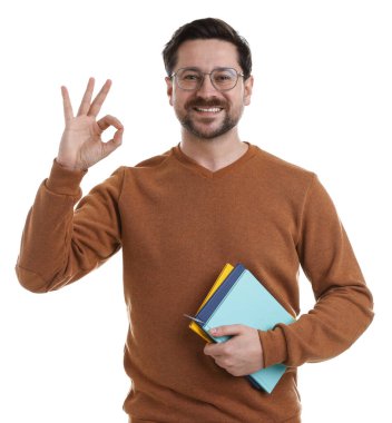 Kitapları olan bir adam beyaz arka planda iyi bir jest gösteriyor