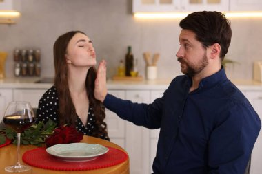 Kötü randevu. Evde yemek yerken masadaki bir kadından öpüşmeyi reddeden utangaç adam.