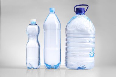 Farklı boyutlarda su şişeleri beyaz üzerine izole edilmiş.