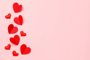 Pembe arka planda bir sürü kırmızı kalp var. Metin için boşluk