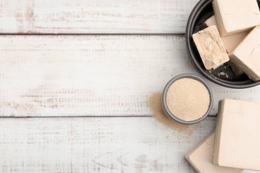 Kasede kurutulmuş maya ve açık ahşap masada taze mayalar. Metin için boşluk