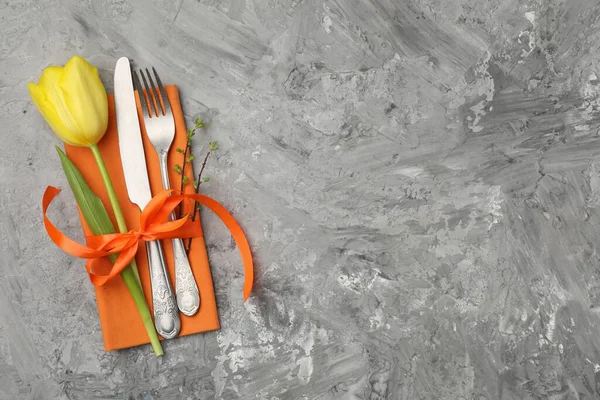 Paskalya sofrası. Gri arka planda lalesi olan güzel gümüş takımlar, üst manzara. Metin için boşluk